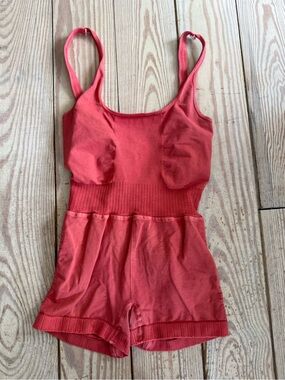 Free People Movement Good Karma Runsie in a washed red color xs/s